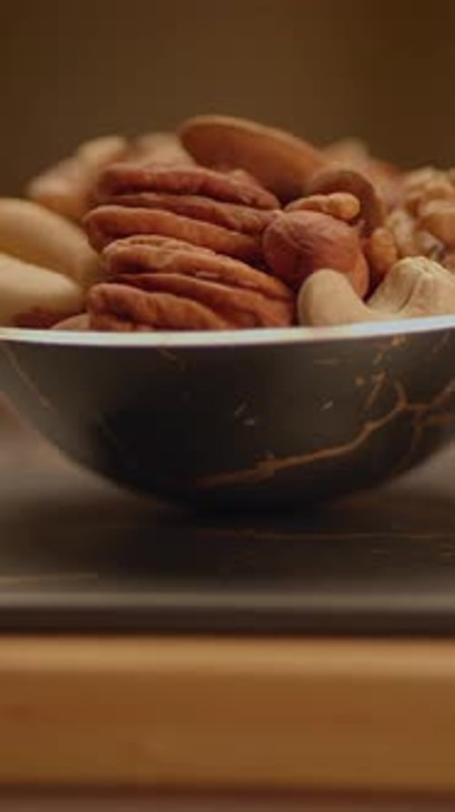 A Beautifully Presented Assortment of Various Nuts in an Elegant Decorative Bowl