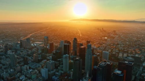 Scenic view of the sun-dazzled misty metropolis. Aerial perspective of Los Angeles, California, USA