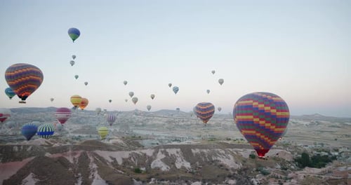 Hot Air Balloons Floating Over Valley at Sunrise