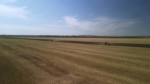 Green Tractor Plowing the Fields with Plow