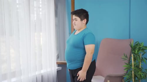 Young Teen Standing Inside Posing Next to Window