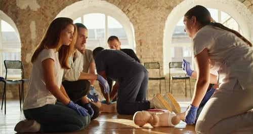 Adults Learning Infant CPR in First Aid Training