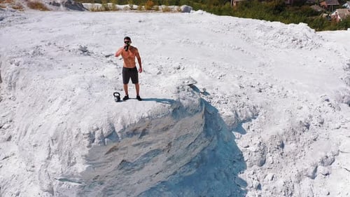 Professional bodybuilder posing outdoors. Concept of beautiful healthy body. Aerial view