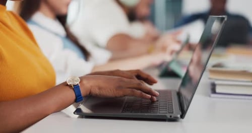 People Working On Laptops At A Long Table