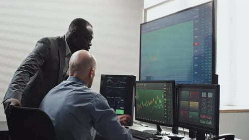 Two Men Co-working In Brokerage Company