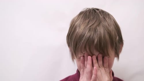 Person Covers Face with Hands in Close Up