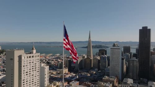 American Flag Waving Over San Francisco Skyline