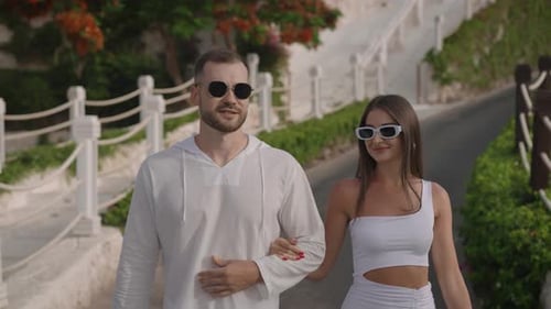 A Young Couple Spend Their Summer Vacation in a Chic Hotel Resort A Man and a Woman in Light