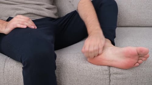 Close Up Of Person Scratching Itchy Foot