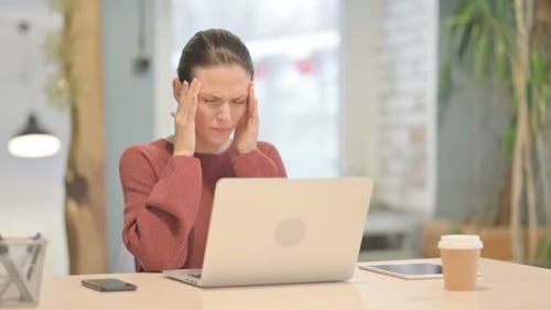 Woman Working at Laptop Experiencing Headache