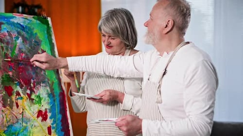 Senior Couple Painting a Colorful Abstract Together