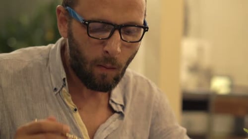 Young Man Eating Meal in Cafe 30s
