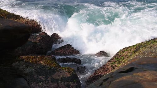 Waves Crash Against Rugged Rocks Sea Spray Rises Force of Nature Scene with Dynamic Ocean Swells