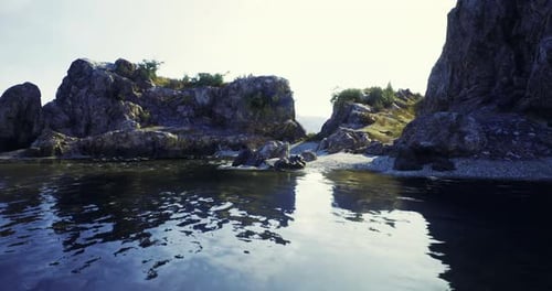 Rocky Shoreline with Clear Water and Gentle Waves in a Serene Coastal Area