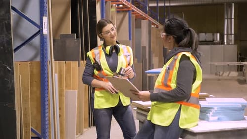 Workers Discussing Work in Distribution Warehouse Adult