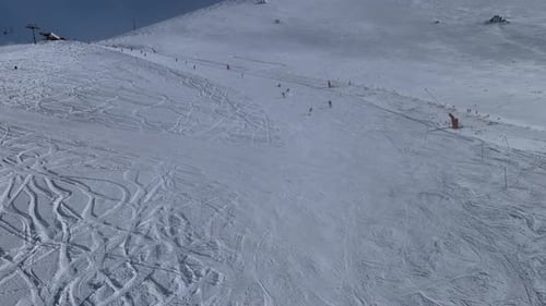 Skiers on Snowy Mountain Slopes in Winter