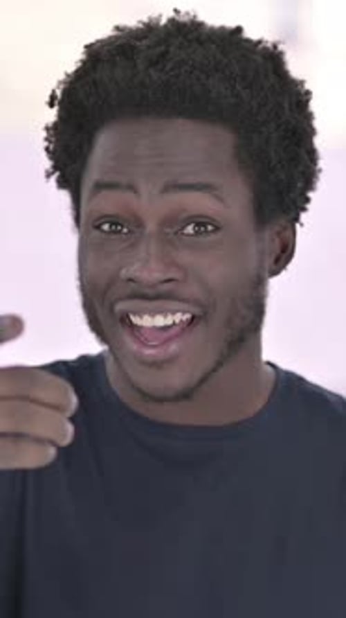 African Man doing Video Chat on Office Desk, vertical video