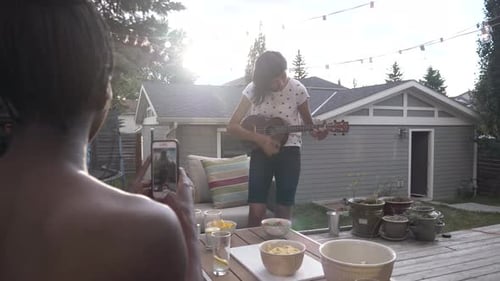 Women Enjoying Music on Patio