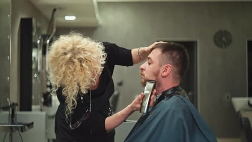 Beautician Trimming Beard in Modern Salon
