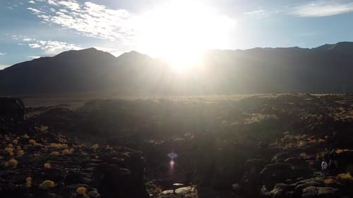 Aerial shot of sunrise behind the mountains with cloudscape. .Beautiful sunset above mountains; the