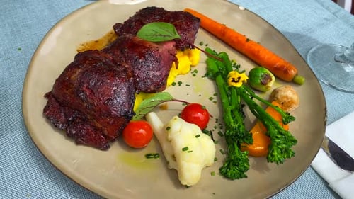 Tender slow cooked pork cheeks and vegetables on a plate, tasty food in a restaurant, 4K shot