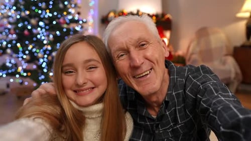 Happy Teen and Grandfather Celebrating Christmas Together