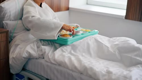 Close-up shot of a tray with healthy food for patient in hospital room in inpatient medical center