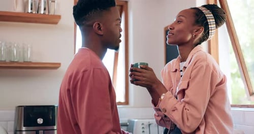 Young Couple Talking and Drinking Coffee in Kitchen