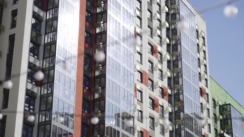 Residential Building with Glass Facade and Lamp Garland