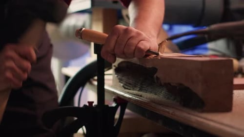 Woodworking Professional in Studio Shaping Wooden Pieces Close Up
