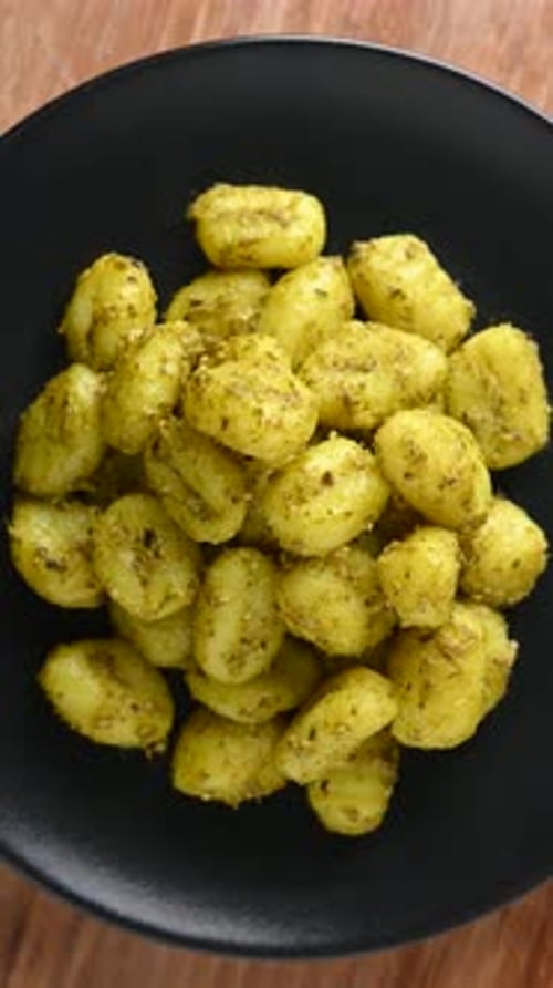 Delicious Pesto Gnocchi on a Black Plate
