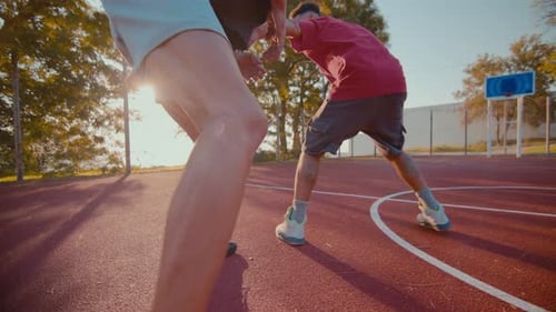 Men Playing Basketball One on One Outdoors