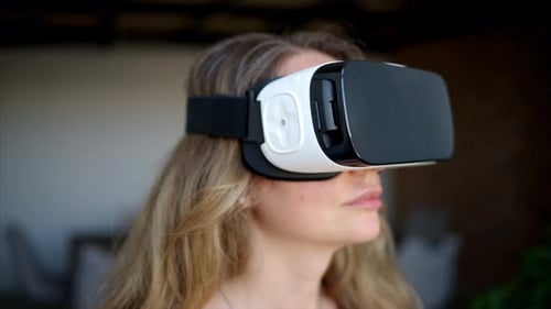 Woman Using Virtual Reality Headset Technology Indoors