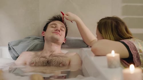 Relaxing Couple in Bubble Bath with Candles