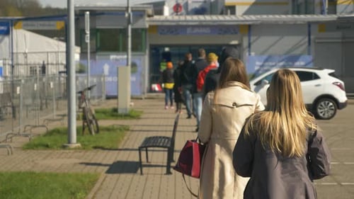 Slowly moving line to the entrance of vaccination centre. Covid-19 vaccination.