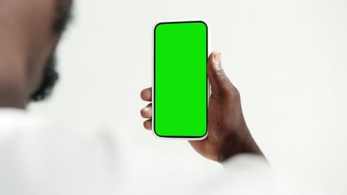 Young African Person Use Smartphone with Green Screen Chroma Key Closeup
