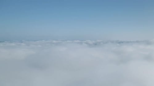 Scenic Aerial View Above White Clouds on Bright Day