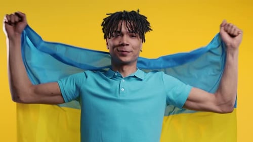 Young Adult Holds National Flag with Pride