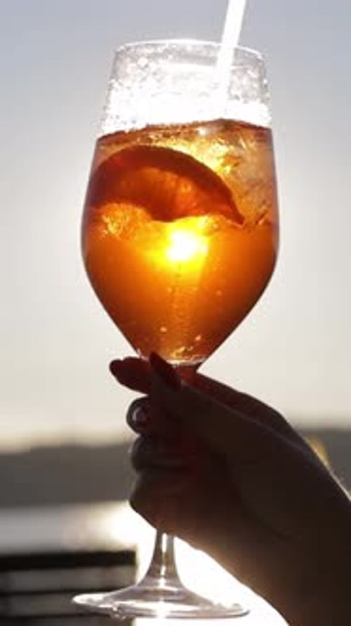 Video Featuring a Woman Enjoying a Refreshing Glass of Orange Juice with a Straw Followed By a