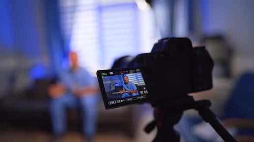 Man on Camera Recording Video at Home