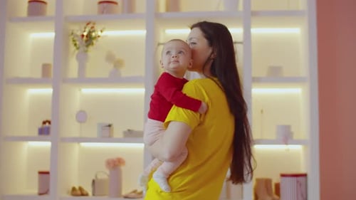 Mother Holds Adorable Baby in Brightly Lit Home