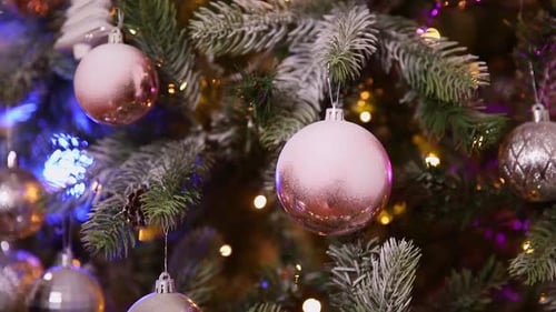 Close Up Of Christmas Tree With Pink and Silver Ornaments
