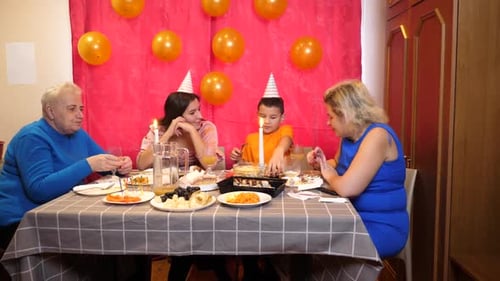 Family Celebrates a Birthday Together Indoors