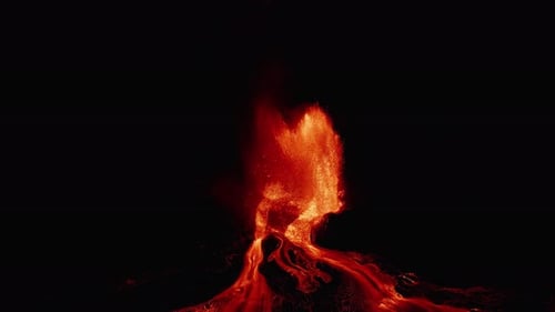 Fiery lava fountain erupts under night sky with glowing lava trails – aerial capture