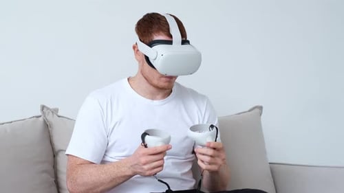 Young Adult Using VR Headset and Controllers