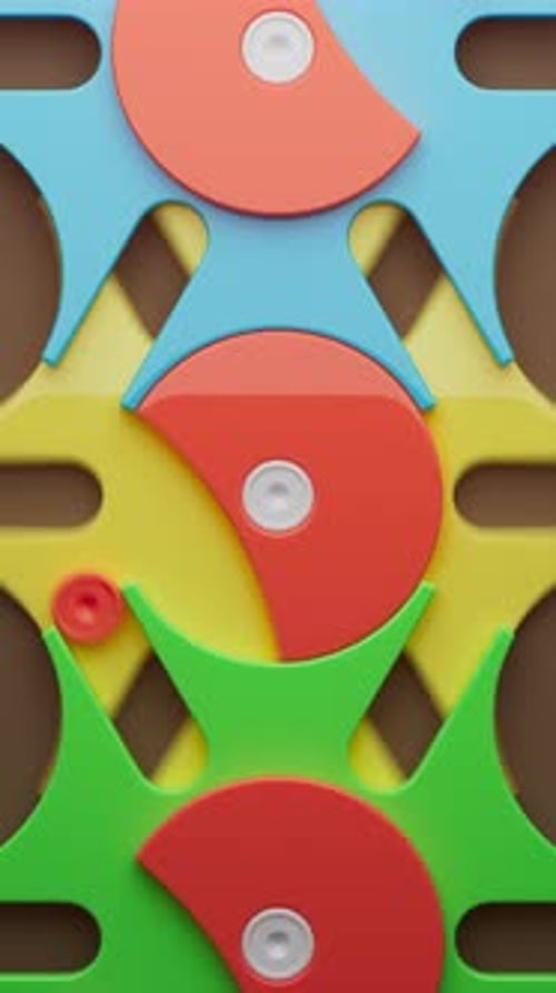 Looped rotation of colorful plastic gears in blue, yellow, green, and red.