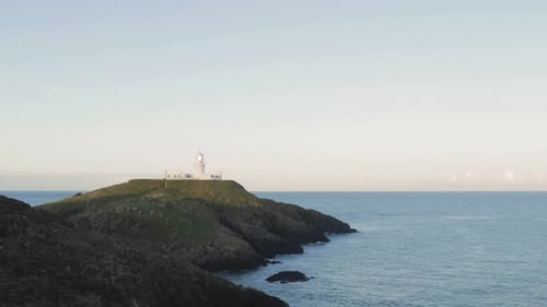 Lighthouse on coast sea cliffs.