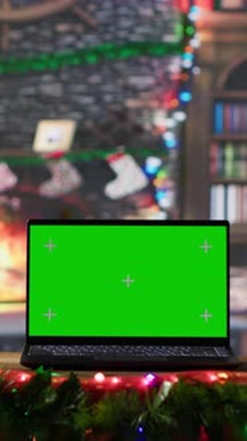 Vertical Video Warm Festive Empty Log Cabin with a Green Screen Running on Laptop