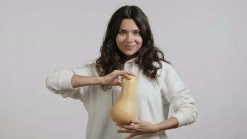 Woman Holds Butternut Squash and Smiles