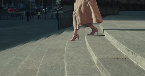 Successful Beautiful Young Female Executive Manager Walks Down Sunny Morning City Steps with Coffee